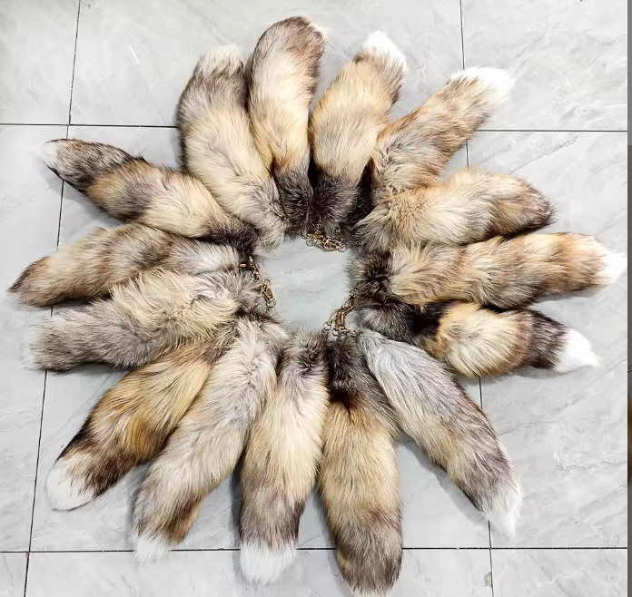 Beige fox tails arranged in a circle on a tile floor