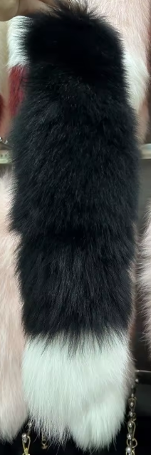 Black and white fur product on a plain background