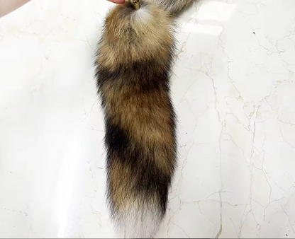 Realistic fox tail with brown and black fur on a white background