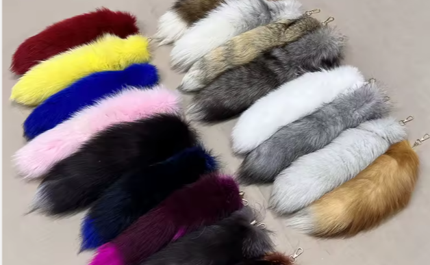 Assorted colorful fur tails on a neutral background