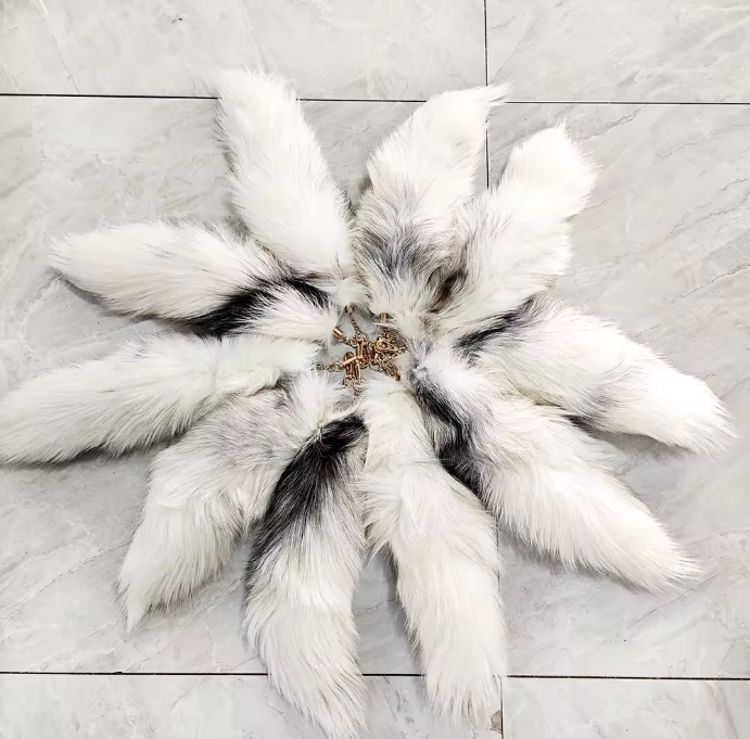 Ivory fox tails arranged in a circle on a tile floor