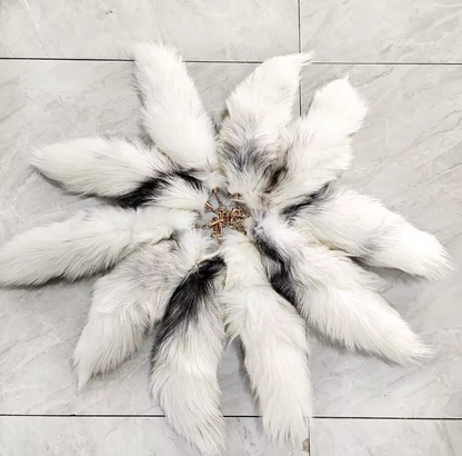 Ivory fox tails arranged in a circle on a tile floor