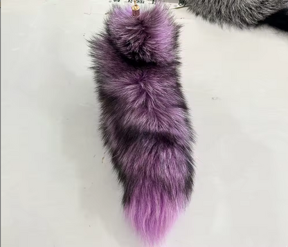 Purple and gray fur tail keychain on a white background