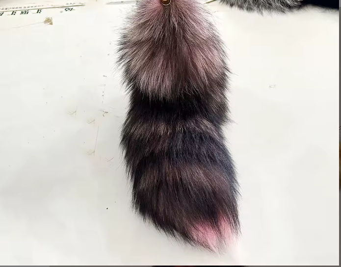 Realistic fox tail keychain on a white background