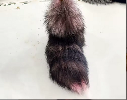 Realistic fox tail keychain on a white background