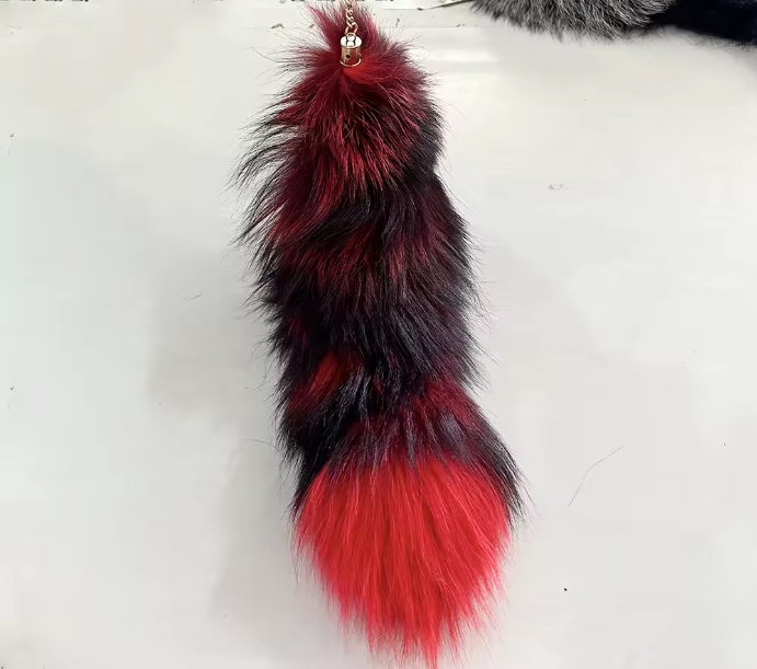Red and black fur keychain on a white background