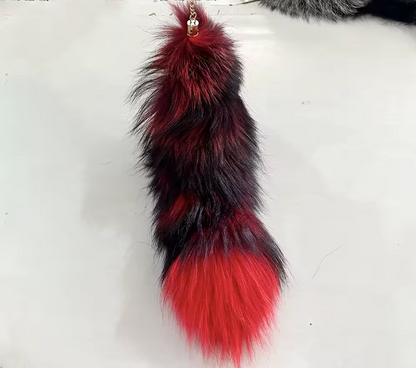 Red and black fur keychain on a white background