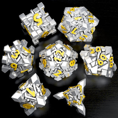 A set of silver dice with gold numbering, arranged on a dark surface. 